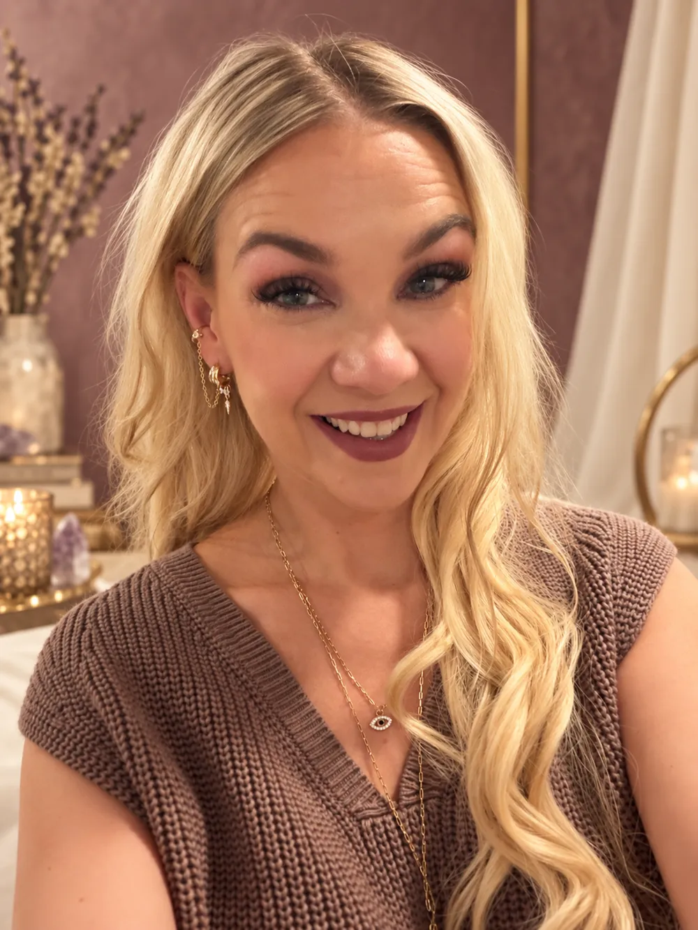 Jaclyn smiling warmly in a cozy candlelit room